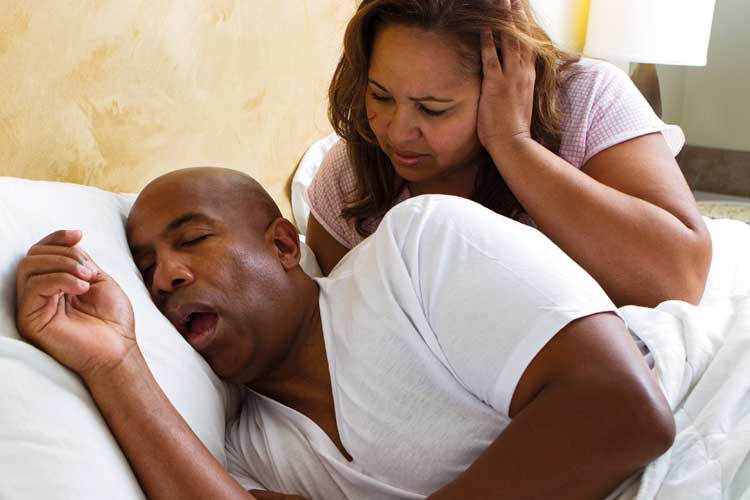 Woman annoyed with snoring man